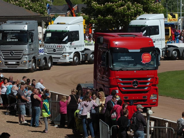 Crowds soak up the sun as trucks parade around the main ring at Truckfest 2011.