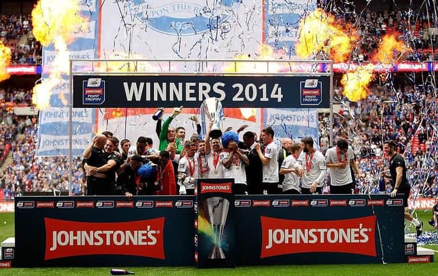 Peterborough United's players celebrate with the trophy after winning the Johnstone's Paint Trophy at Wembley Stadium on March 30, 2014.
