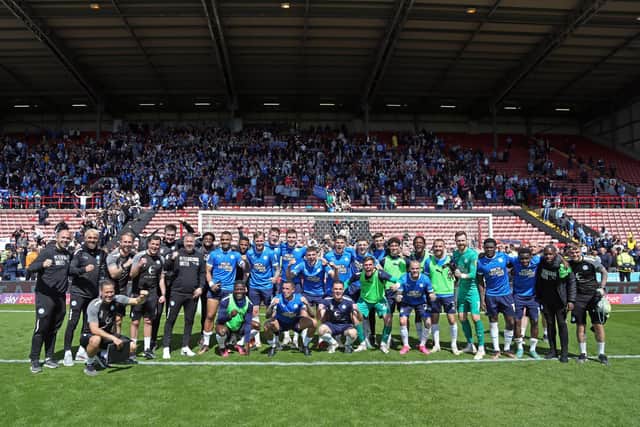 Posh's players and fans celebrate together after securing a play-off place. Photo: Joe Dent.