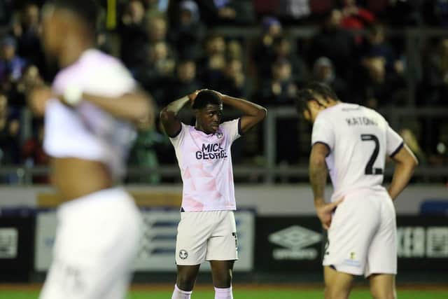 Kwame Poku of Peterborough United cuts a dejected figure after Carlisle United score a late equalising goal. Photo: Joe Dent.