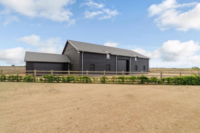 A contemporary home set in open countryside close to Peterborough includes a detached modern barn