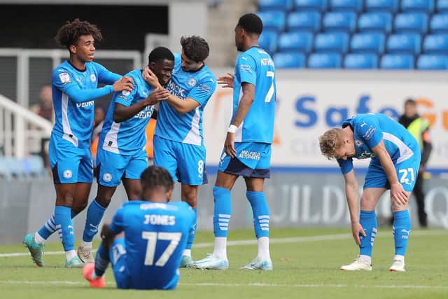 Peterborough United players celebrate the winning goal. Photo: Joe Dent.