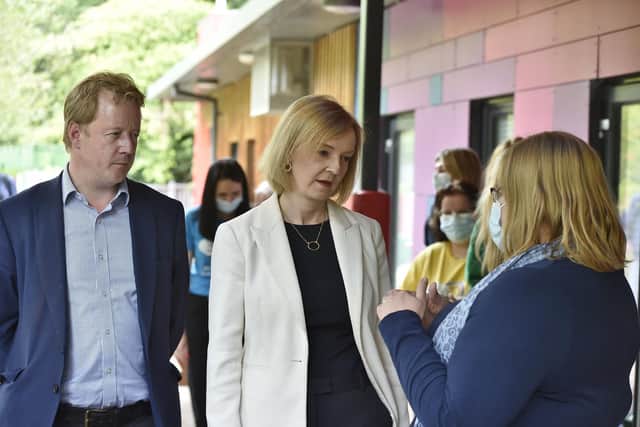 Foreign Secretary Liz Truss speaks to Little Miracles CEO Michelle King and Paul Bristow during her visit to the charity
