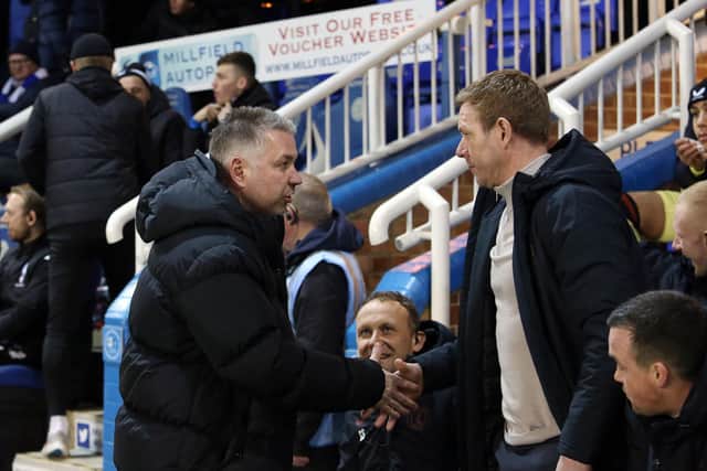 Peterborough United manager Darren Ferguson shakes hands with Charlton Athletic manager Dean Holden ahead of kick-off. Photo: Joe Dent/theposh.com.