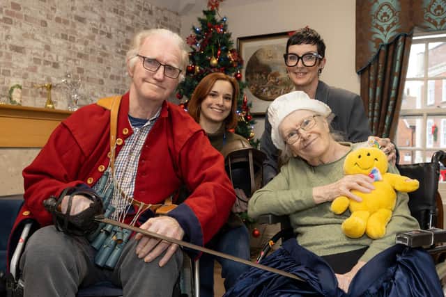 Residents at Cromwell House Care Home explore artefacts from The Cromwell Museum