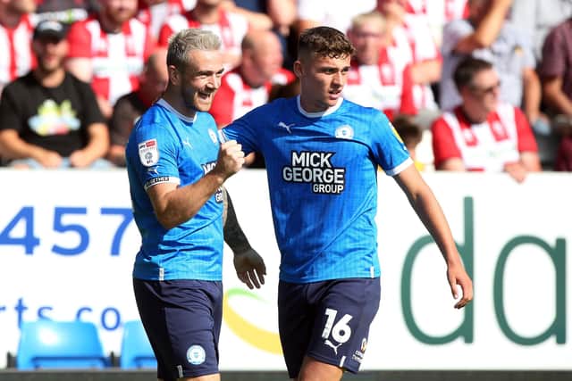 Jack Marriott of Peterborough United celebrates his second and his side's fourth goal of the game with Harrison Burrows. Photo: Joe Dent/theposh.com.