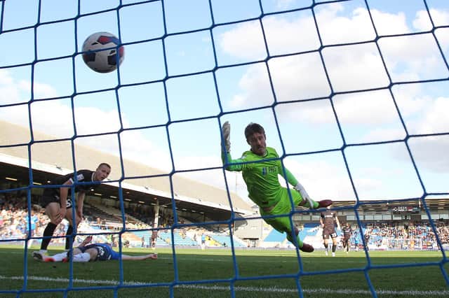 Jonson Clarke-Harris heads in Peterborough United's opening goal. Photo: Joe Dent.
