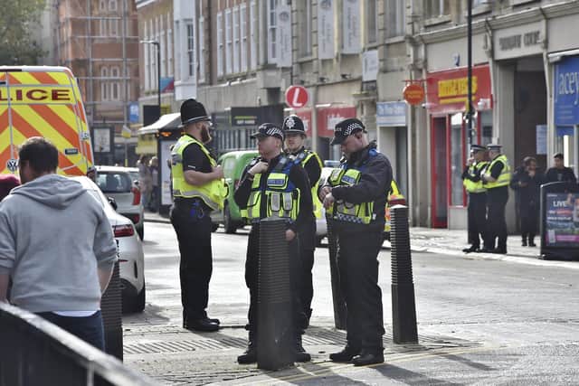 Police and football fans in the city centre before the Cambridge game