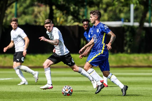 Kyle Barker (left) of Posh in action with Christian Pulisic of Chelsea. Joe Dent/theposh.com
