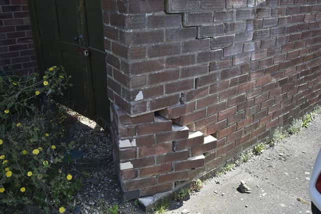 Damage done to the car park wall, which has been repaired to an extent.