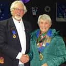 New Peterborough League president Angela Turner receives the chain of office from outgoing president Martin Garfield.