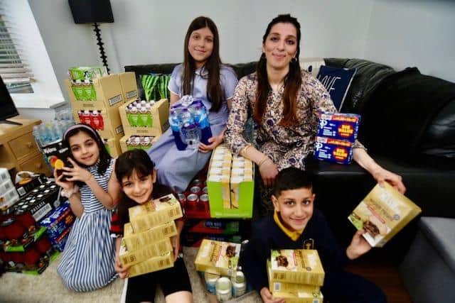 Rabeea Khalil, 39, and her four children Emman, 10, Aizah, 8, Mustafaa, 7 and Raiya, 6 pictured with their donations (image: David Lowndes)