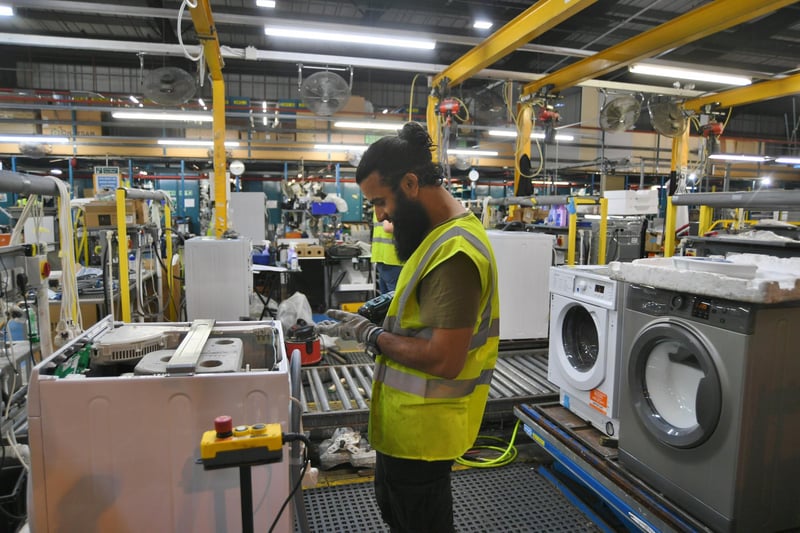 A members of staff tests a repaired machine at Whirlpool in Peterborough