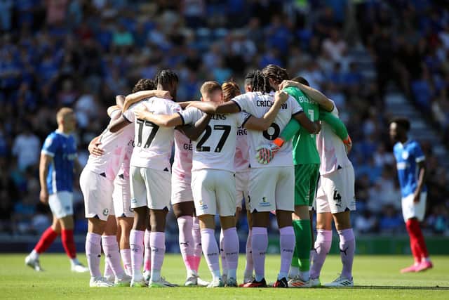Peterborough United players huddle together prior to kick-off against Portsmouth. Photo: Joe Dent.