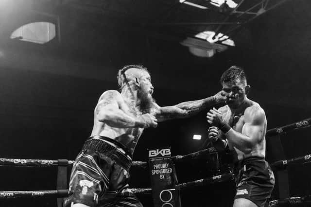 Martin Reffell (left) in British title fight action against Rolando Dy. Photo Brooklyn Freeman.
