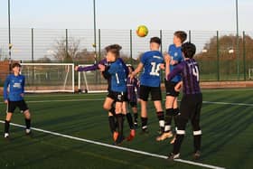 Football action from the schools cup final between Jack Hunt and Nene Park Academy (blue) at St John Fisher. Photo: David Lowndes