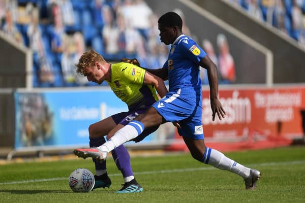 Kwame Poku (blue) in action for Colchester against Exeter in the 2020 League Two play-offs. Photo:Justin Setterfield/Getty Images.