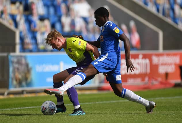Kwame Poku (blue) in action for Colchester against Exeter in the 2020 League Two play-offs. Photo:Justin Setterfield/Getty Images.