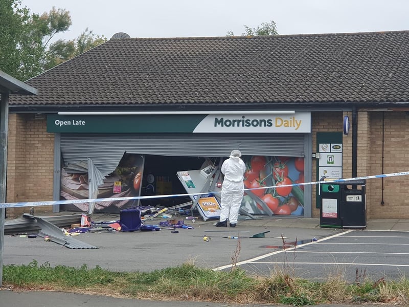 Scenes of crime officers photograph the scene.