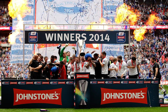 Posh players celebrate with the trophy after winning the Johnstone's Paint Trophy against at Wembley Stadium on March 30, 2014.