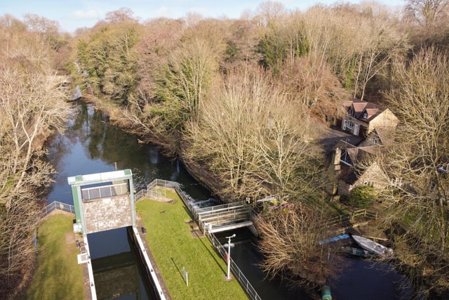 An aerial view of the river, lock and house