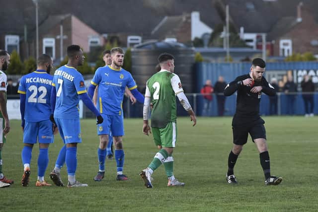 Connor Kennedy (blue, facing) of Peterborough Sports has just been sent off against Kettering Town. Photo: David Lowndes.
