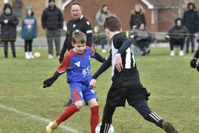 U12 football action from Hampton (blue) v Peterborough Lions at Queens Park, Yaxley. Photo: David Lowndes.