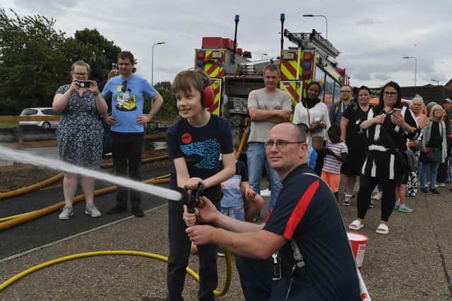 Open day at the Peterborough Volunteers Fire Station at Bourges Boulevard. Henry Begley with fire volunteer George Lee.