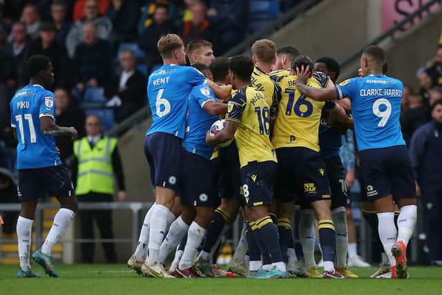 Tempers flare between Oxford United and Peterborough United players with Matty Taylor of Oxford United being sent off for violet conduct. Photo: Joe Dent/theposh.com.