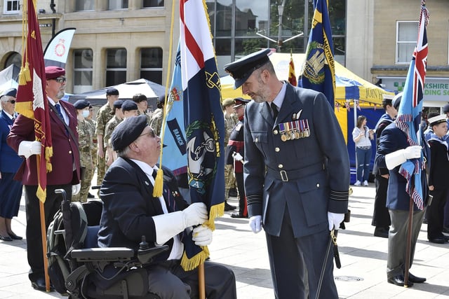Armed Forces Day parade in the city centre. Wing Commander Jeremy Case, Station Commander RAF Wittering, talking to one of the Royal British Legion standard bearers