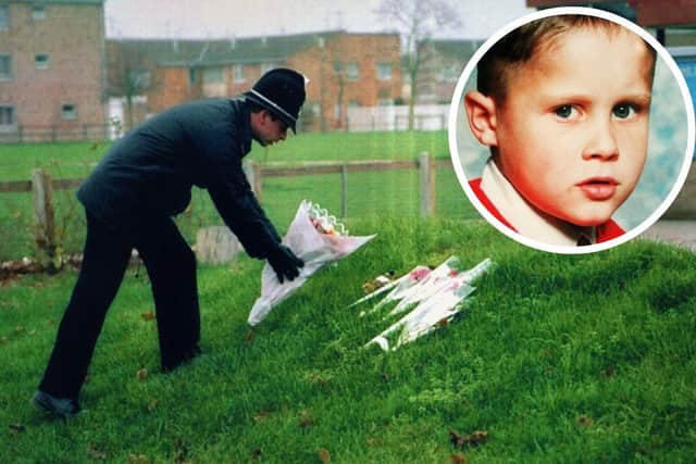 A policeman leaving flowers at Welland County Primary School in Peterborough, the school of murdered six-year-old Rikki Neave on 30/11/94.