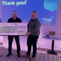 Pete Greaves from the Alzheimer's Society accepts a cheque from Andy Pearce