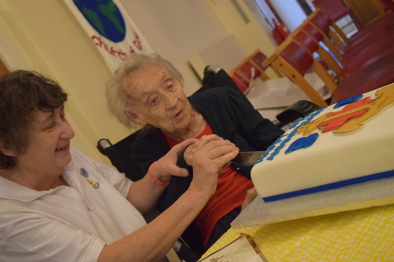 Margaret Parkin cuts the anniversary cake.
