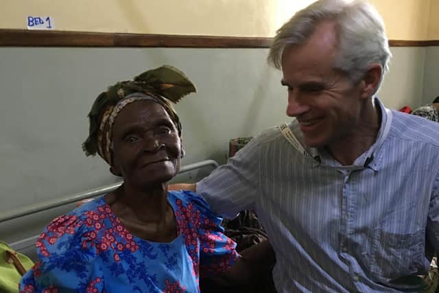 Jonathan Jones with a 90-year-old patient in Malawi following her treatment.
