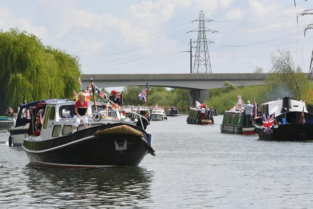The Coronation convoy makes its way along the River Nene.
