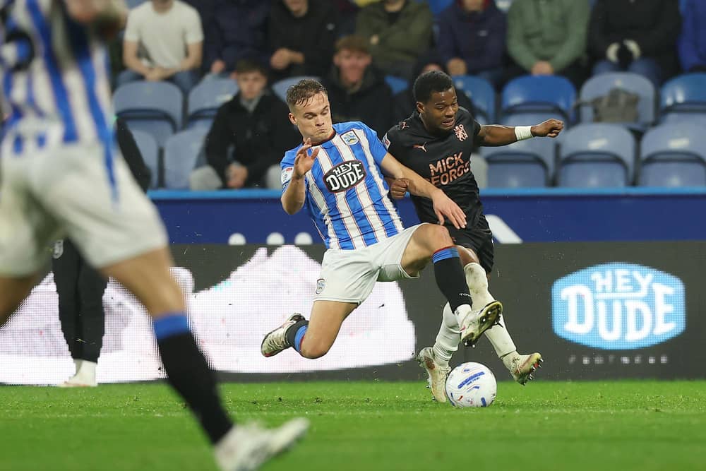 Owura Edwards battles former Peterborough United man Archie Collins. Photo: Joe Dent.