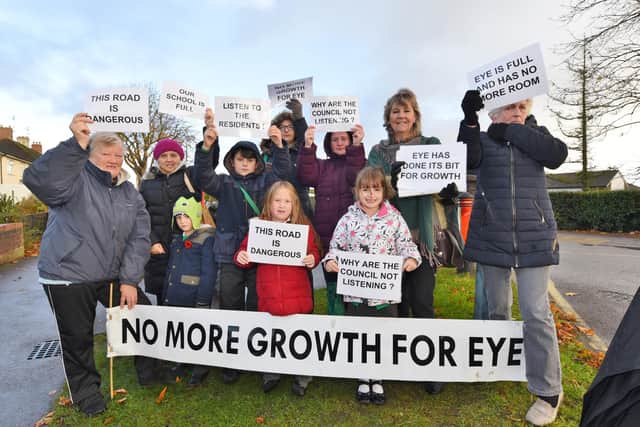 Local residents protest outside Eye primary school against proposed development in the village.