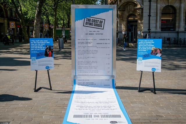 Displayed at Cathedral Arch in Peterborough, the stark 16-ft-long receipt, which overspills its frame and trails along the ground, reveals just how much Sue Ryder’s palliative care and bereavement services cost to run. This coincides with new data showing the cost of Sue Ryder care has increased by 20% and people needing vital end-of-life care is due to increase by 55% by 2030. Photograph commissioned by Sue Ryder and taken by Beth Crockatt. 