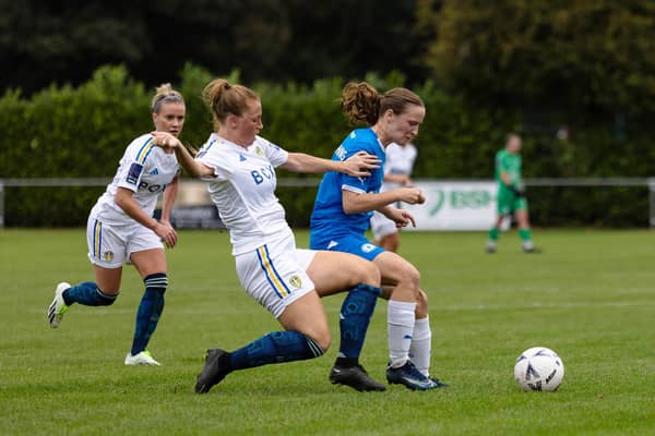 Evie Driscoll-King (blue) in action for Posh Women against Leeds United. Photo: Ruby Red Photography