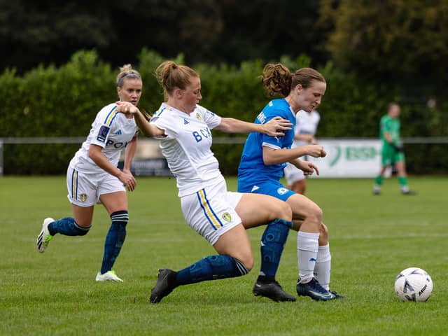 Evie Driscoll-King (blue) in action for Posh Women against Leeds United. Photo: Ruby Red Photography