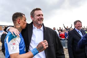 Posh chairman Darragh MacAnthony and Jonson Clarke-Harris celebrate promotion in May, 2021.