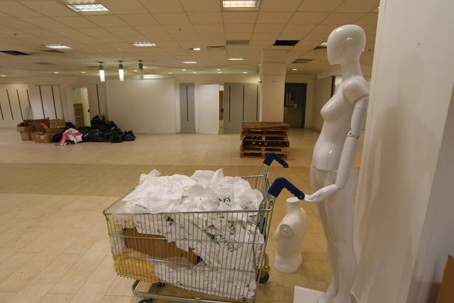 Sense of humour - a mannequin is left 'waiting' with a trolley in the former Beales store in Peterborough.