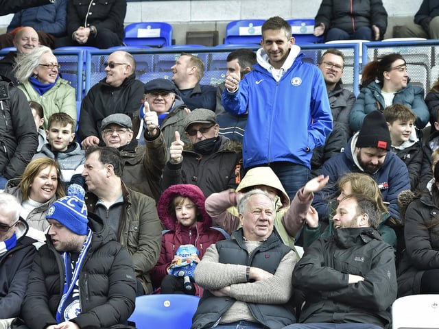 Peterborough United fans are pictured watching the crucial win over Derby County.