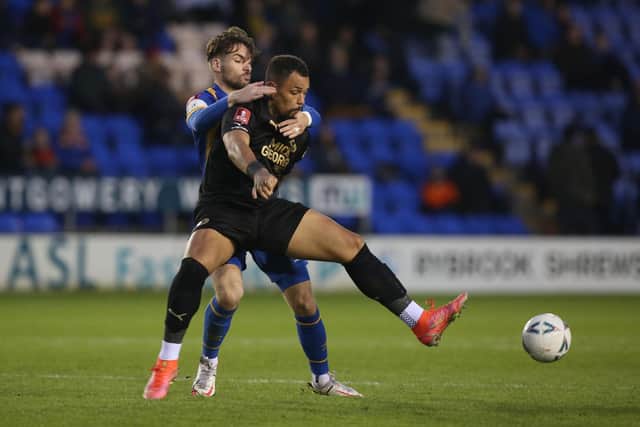 Jonson Clarke-Harris of Peterborough United battles with Luke Leahy of Shrewsbury Town in Saturday's FA Cup tie. Photo: Joe Dent/theposh.com.
