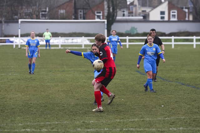 ​Katie Steward (mostly hidden) scores again for Sports v Huntingdon. Photo: Tim Symonds.