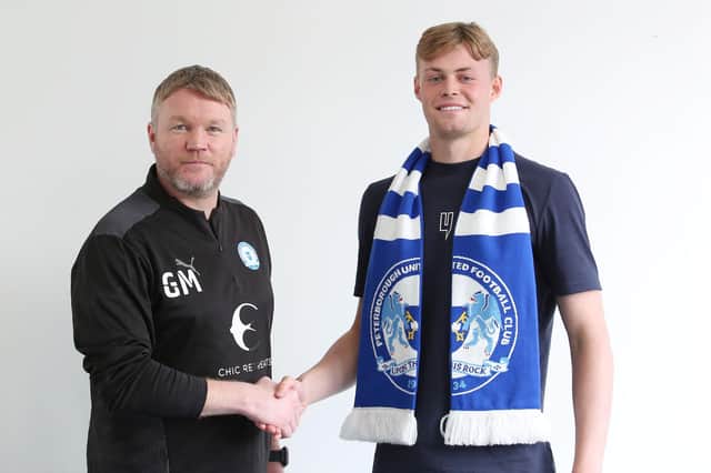 New Posh goalkeeper Harvey Cartwright (right) with manager Grant McCann.
