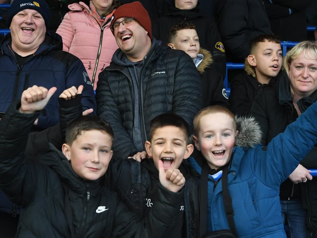 Peterborough United fans watch the defeat to Wigan Athletic.