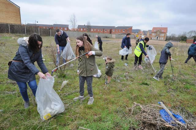 Community litter picking volunteers at work at London Road on the side of the A15 near Drake Avenue.