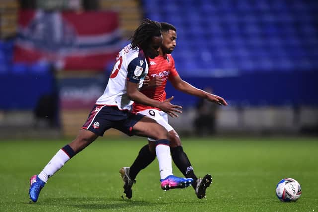 Peter Kioso (white shirt) in action for Bolton in 2020. (Photo by Nathan Stirk/Getty Images).