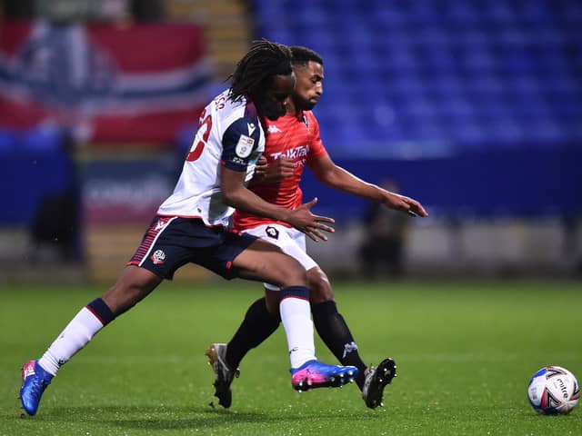 Peter Kioso (white shirt) in action for Bolton in 2020. (Photo by Nathan Stirk/Getty Images).